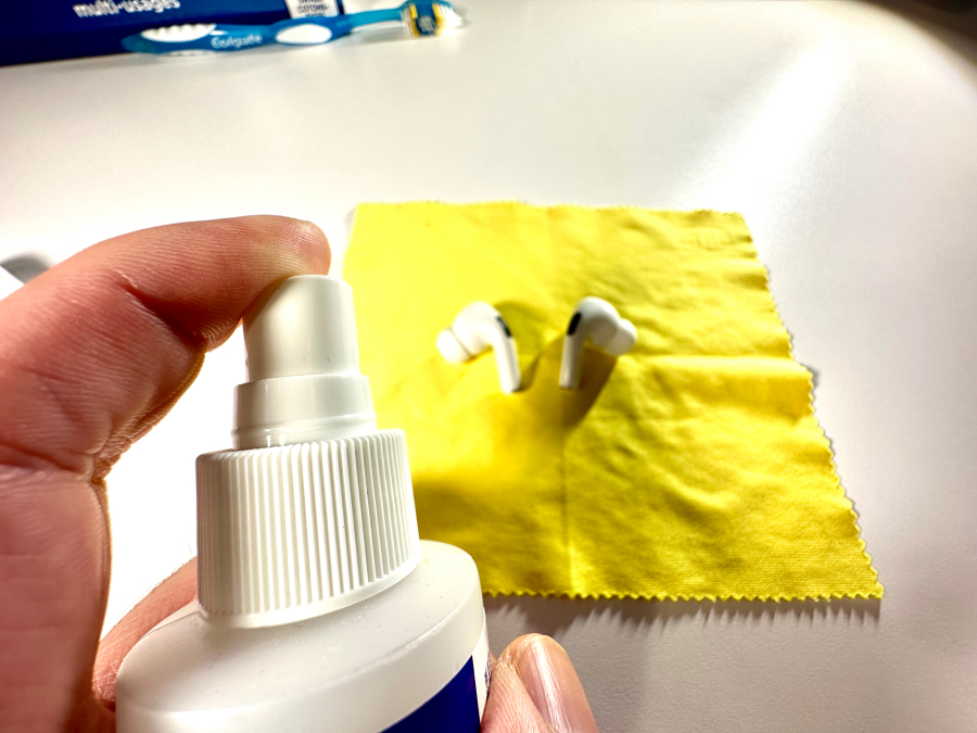 Cleaning AirPods using microfiber cloth and alcohol