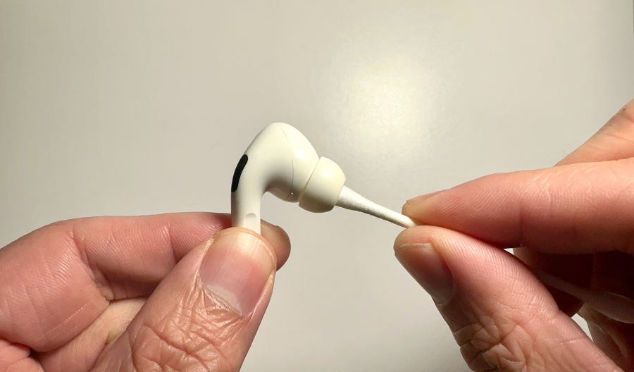 Cleaning AirPods using a Q-tip