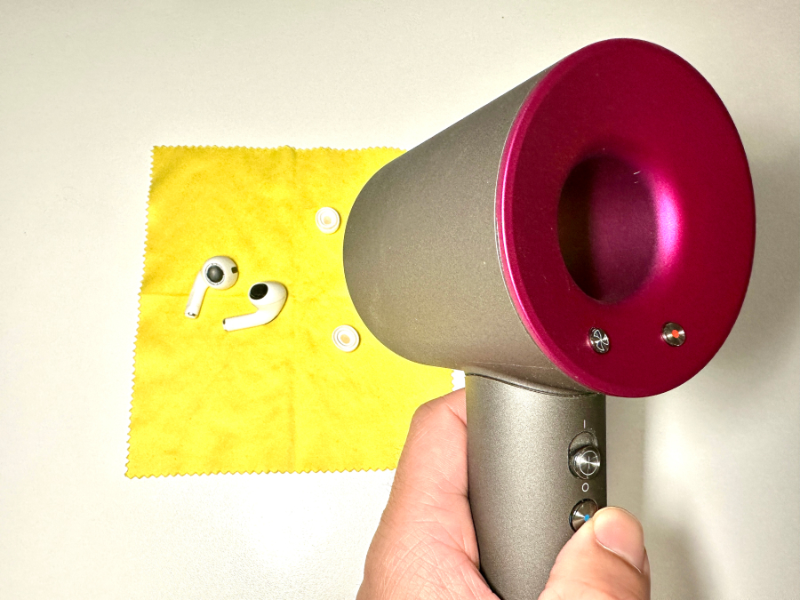 Drying AirPods using a cool setting hairdryer